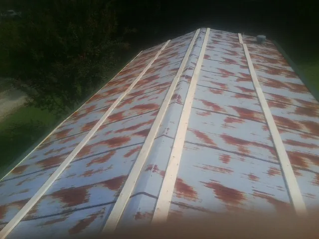 Rusted metal roof panels with new wood purlins before replacement — Storm Damage Roof Repair in Verdon by Roofing Brothers