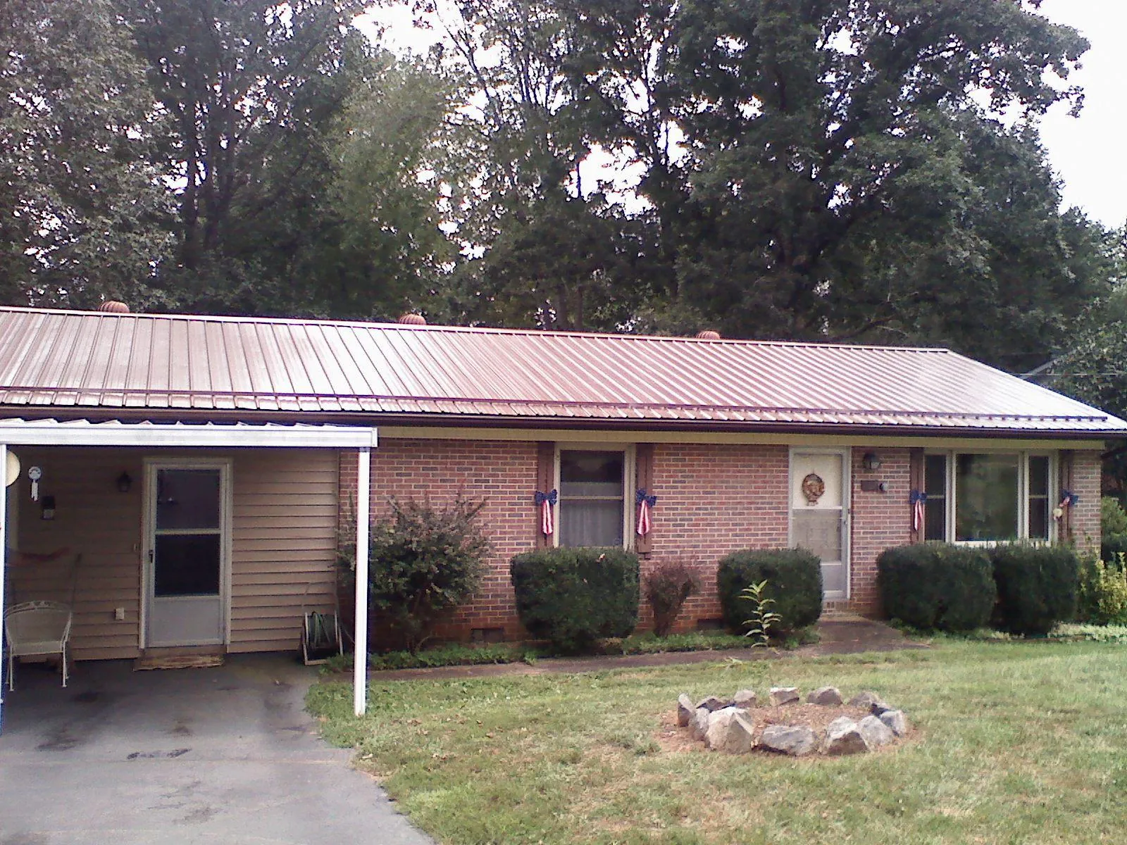 Bronze metal roof and carport on a brick ranch home — Roof Repair work by our crew in Verdon