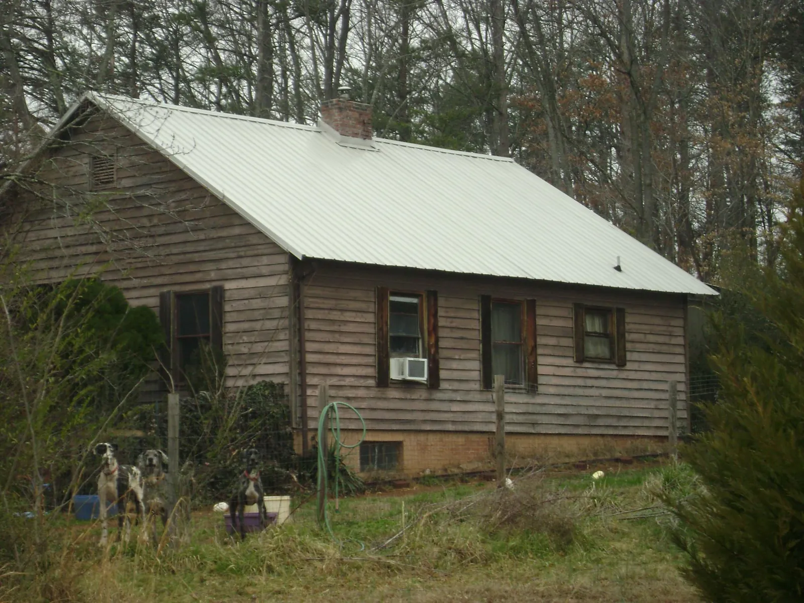 White metal roof on an old wood sided farmhouse, from a Metal Roof Installation job in Verdon